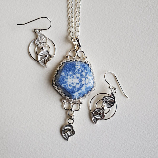 Sterling silver and porcelain pentagon pendant with  blue transferware abstract stippled pattern.  Has Yin and Yang  leaf motif matching earrings to accompany design of pendant. 22 inch sterling chain included. 